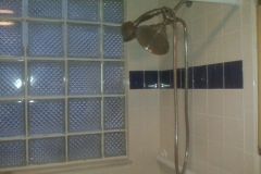 Shower remodeled with white and blue tile