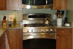 Kitchen in Bethesda w/Oak Cabinets and Sea Green Granite Countertop